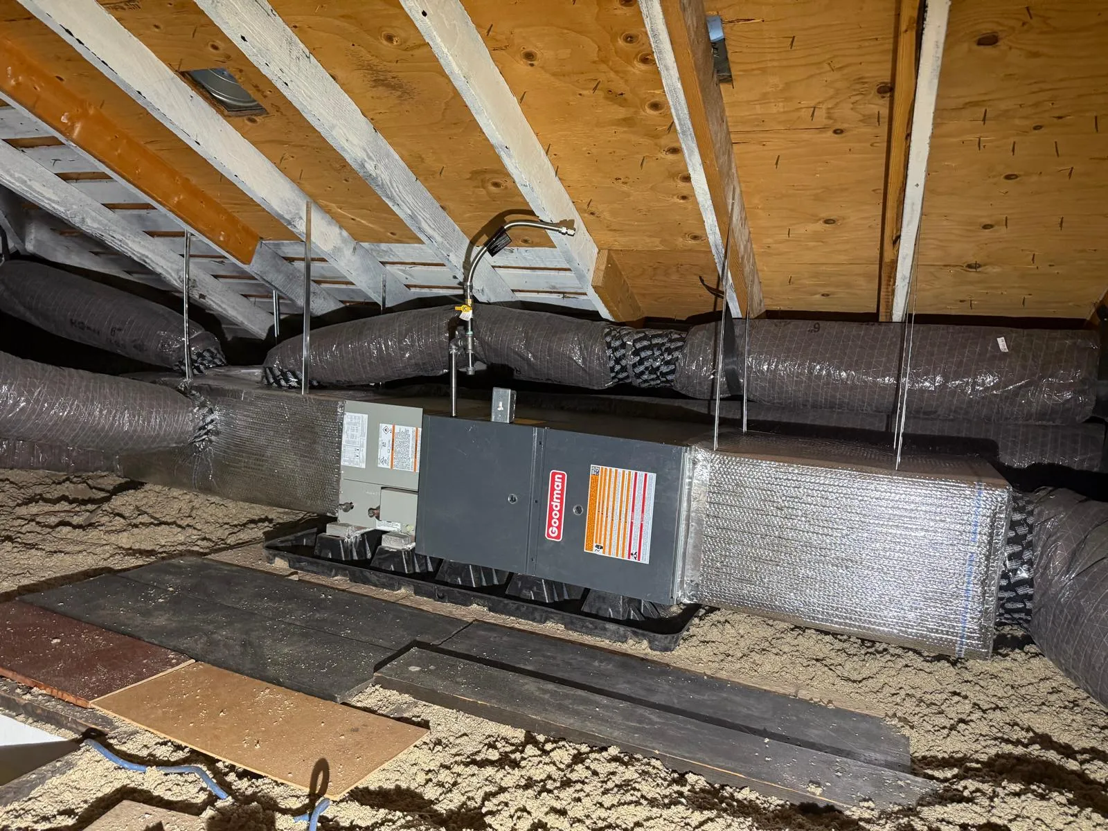 New insulated ductwork and Goodman air handler installed by Lucas Heating and Air in a Salt Lake City attic