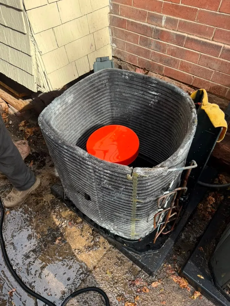 Condenser cabinet opened at a Holladay home with the compressor exposed mid-replacement