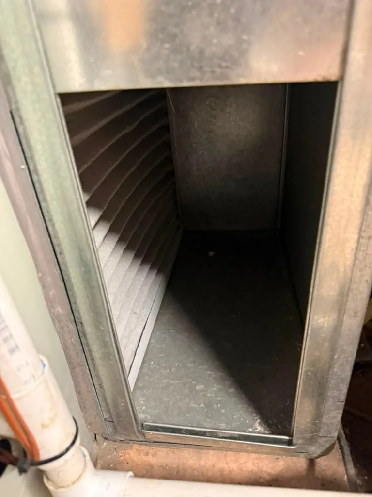 Open furnace filter rack during a Lucas Heating and Air filter check at a West Valley City home