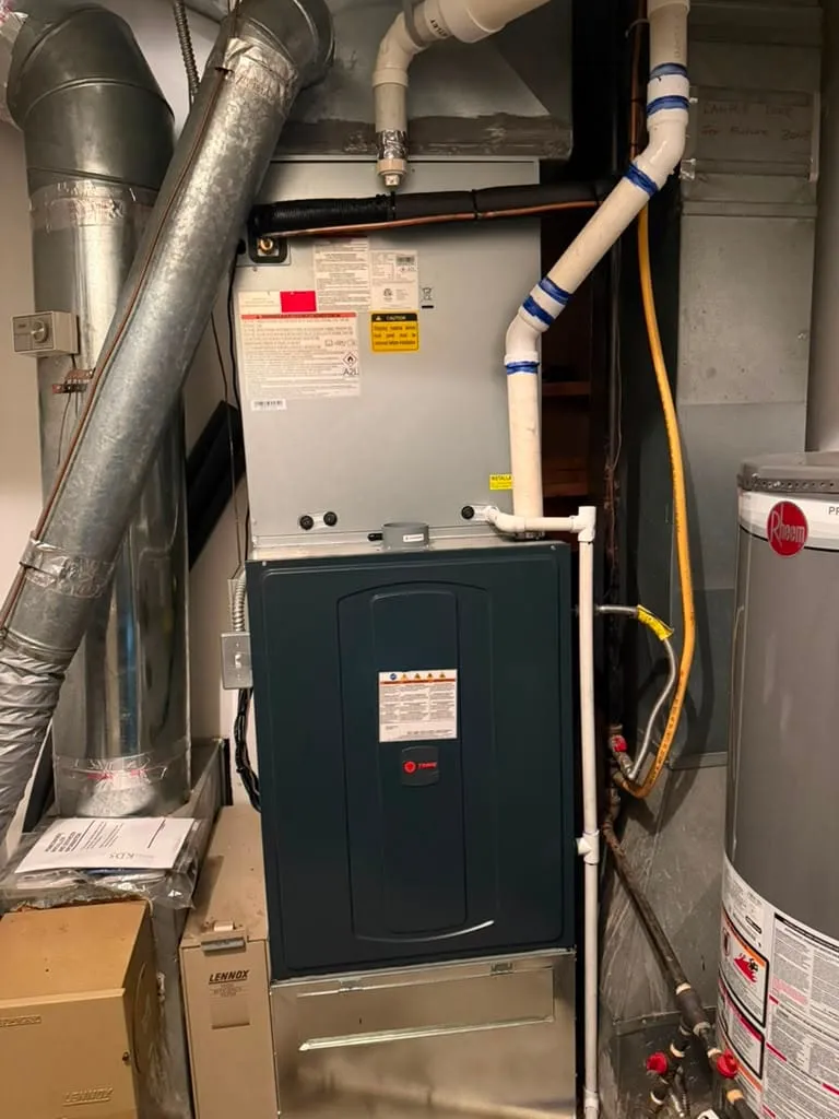 High-efficiency Trane furnace and new AC coil installed by Lucas Heating and Air in a Millcreek basement, with PVC venting
