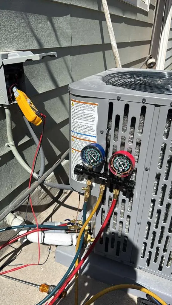 Lucas Heating and Air gauges and meter hooked to an AC condenser during a refrigerant check in Murray
