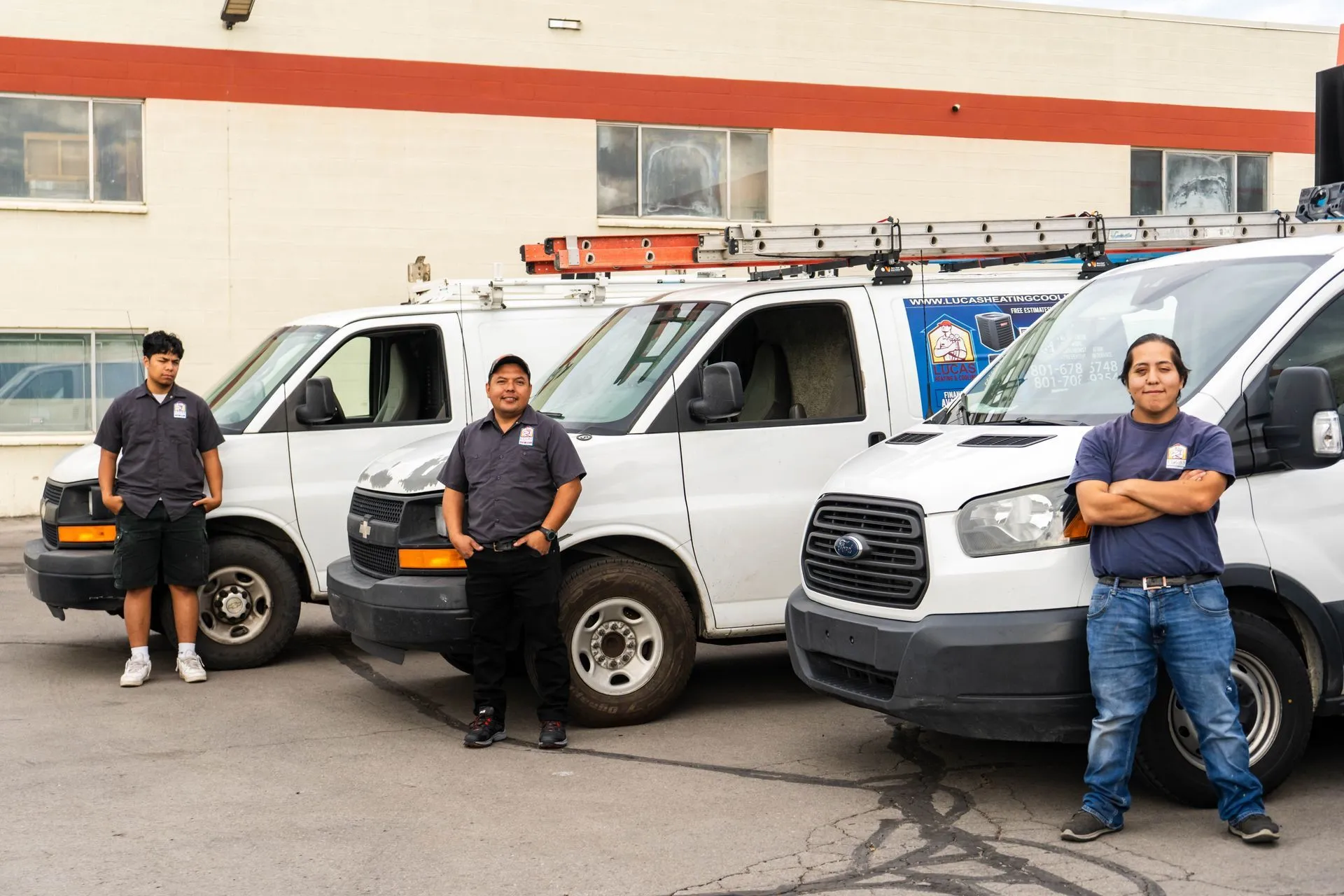 Lucas Heating and Air commercial service crew with three work vans