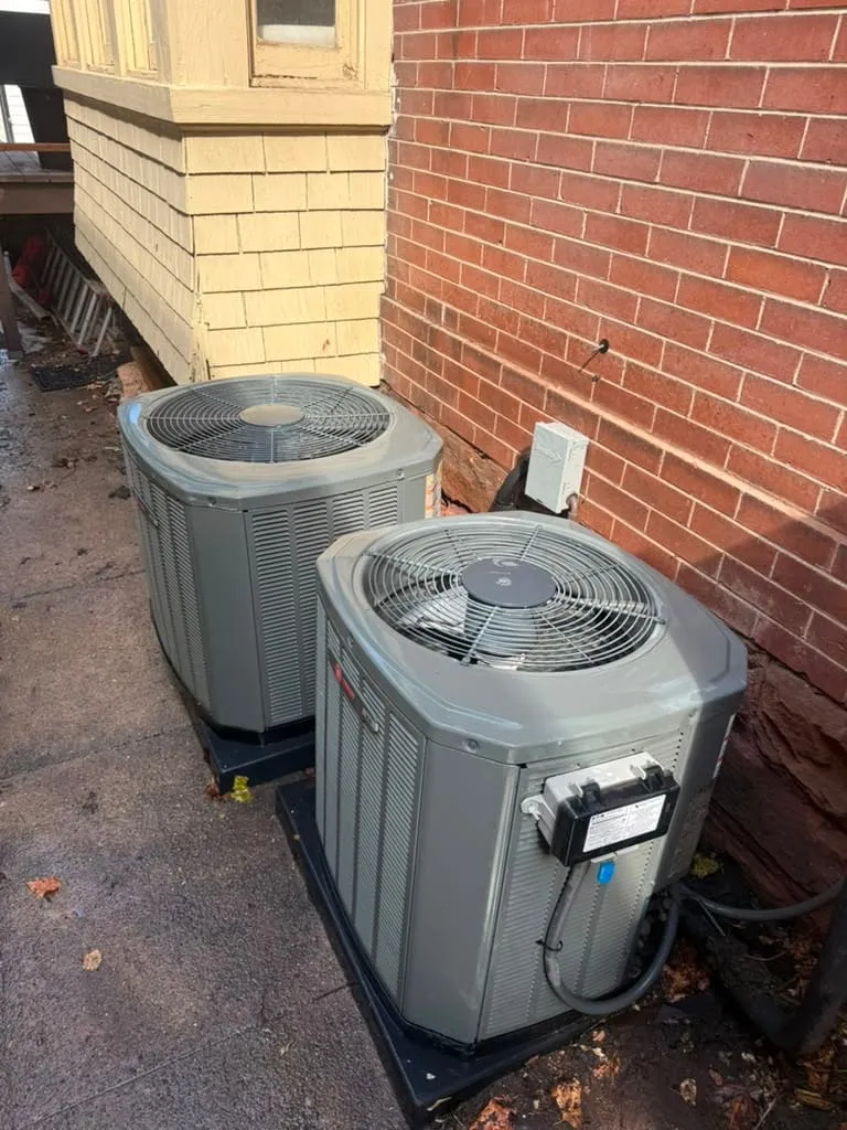 Two new AC condensers installed at a Holladay home, a Trane unit in the foreground